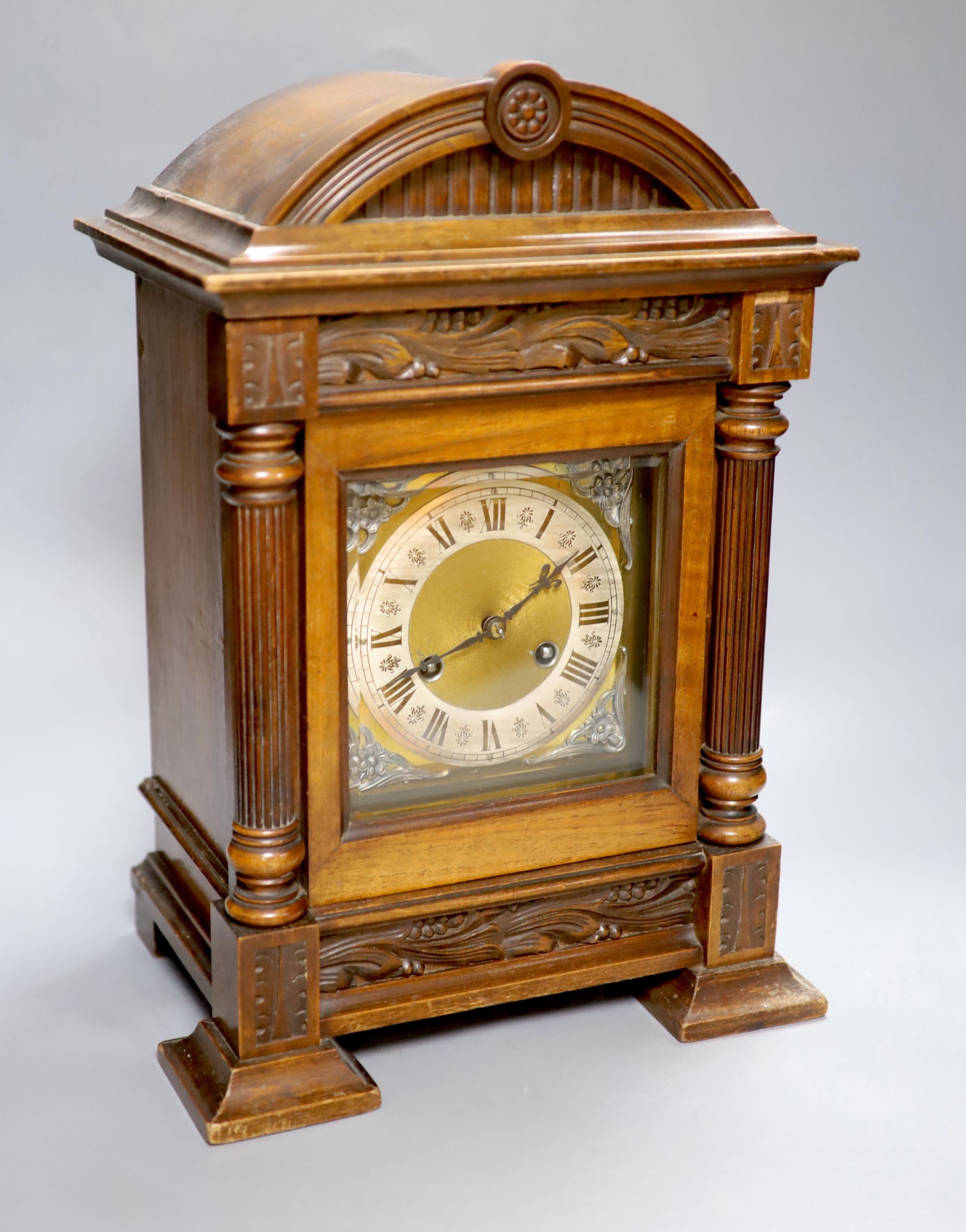 A German walnut mantel clock, converted to electric regulation, height 44cm